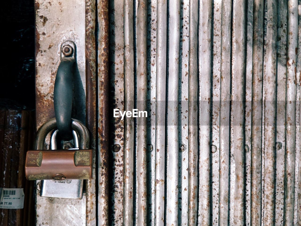 Close-up of padlocks on metal gate