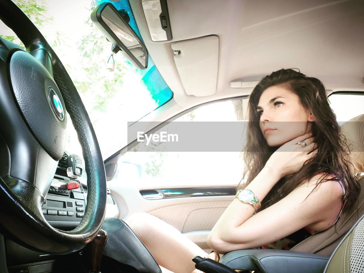 PORTRAIT OF WOMAN SITTING IN CAR