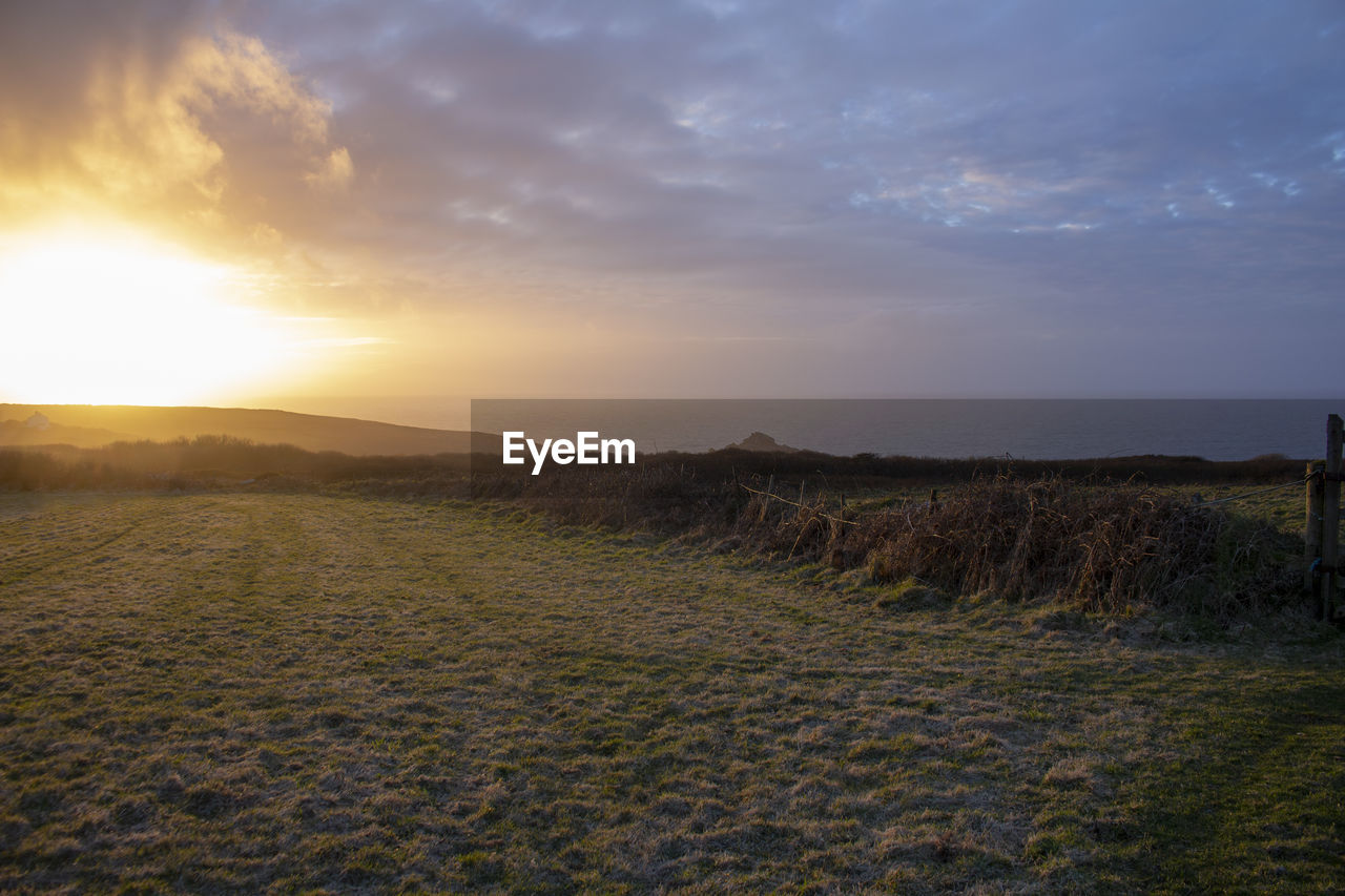 SCENIC VIEW OF SUNSET OVER LAND