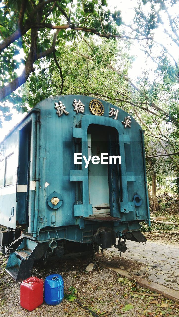 Low angle view of old train against trees in forest