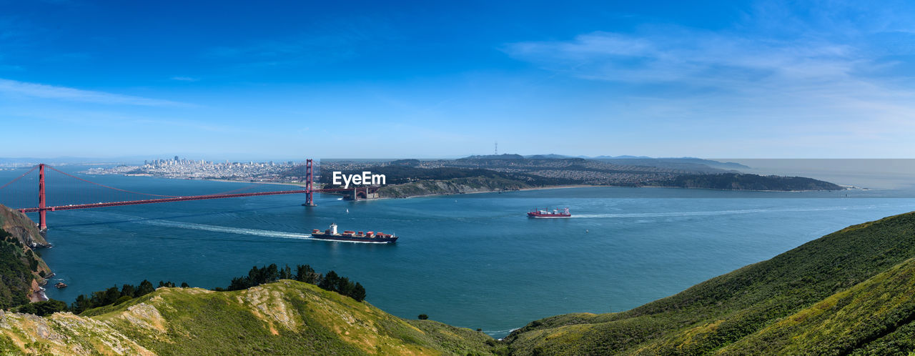 Golden gate bridge over bay against cloudy sky