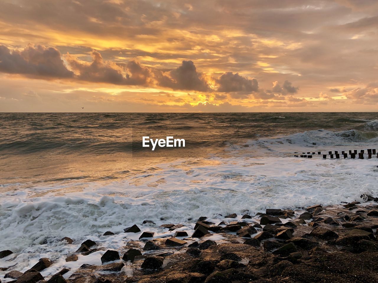 SCENIC VIEW OF BEACH DURING SUNSET