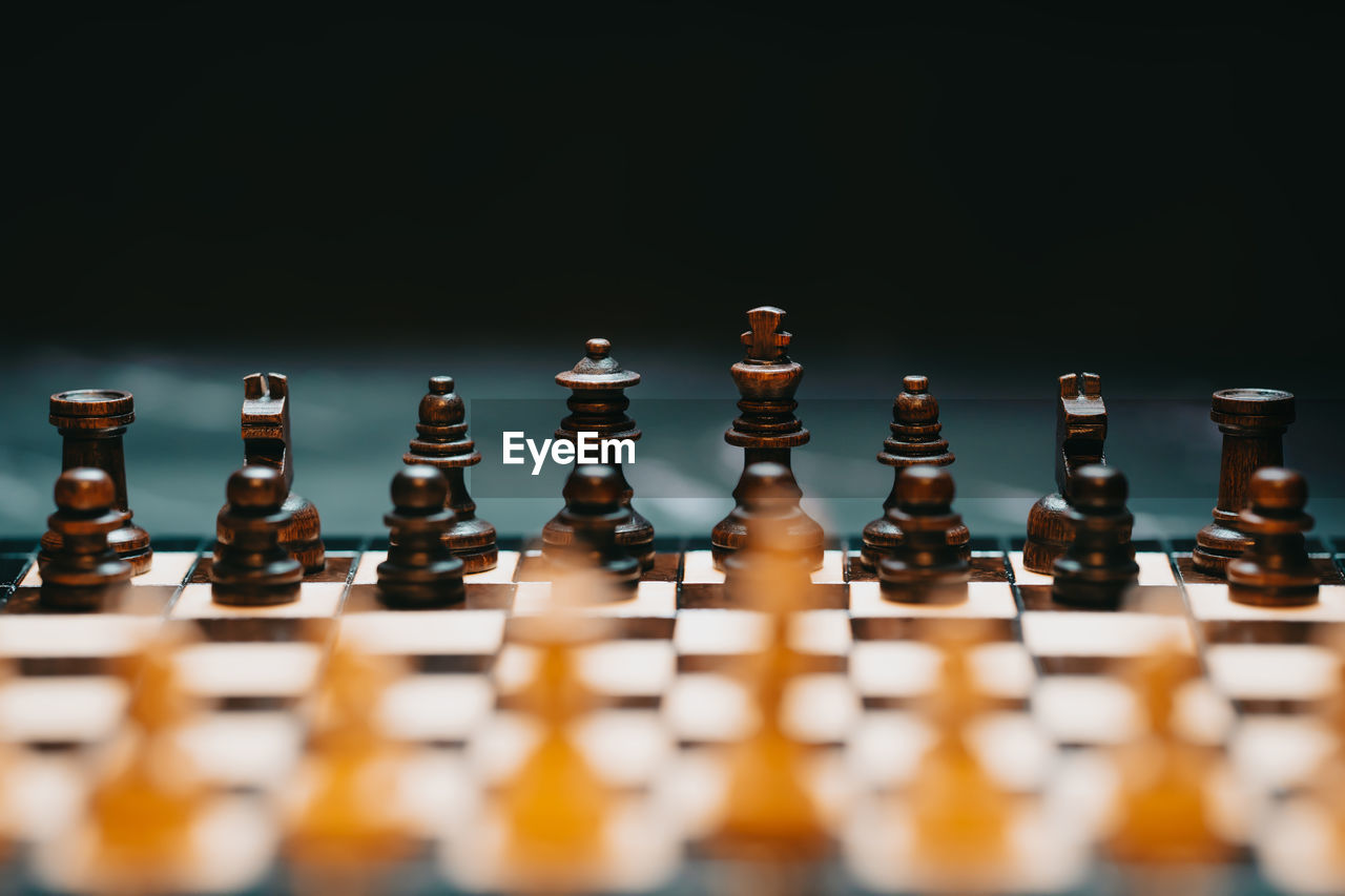 Close-up of chess pieces against black background