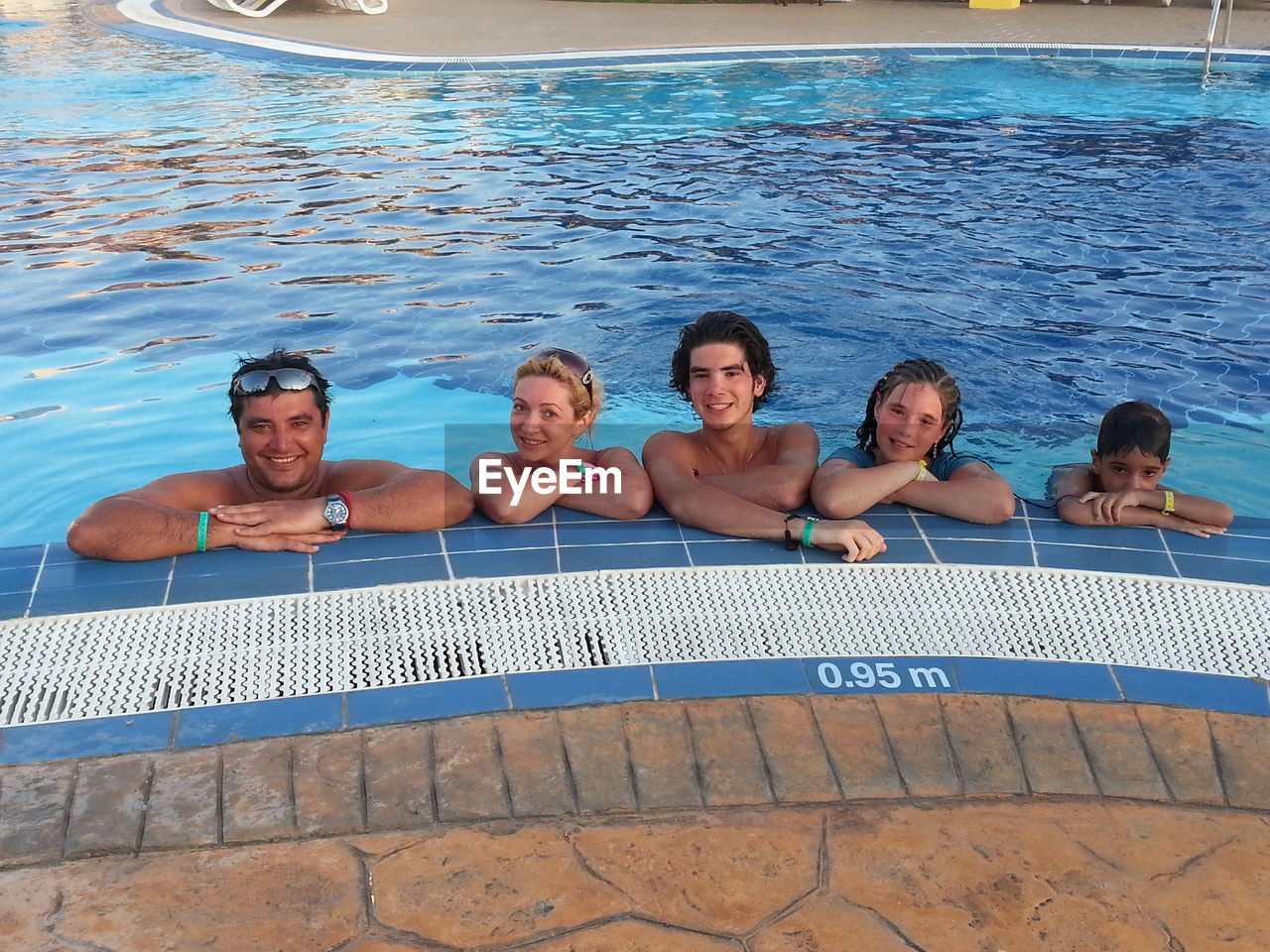 Portrait of smiling family at poolside