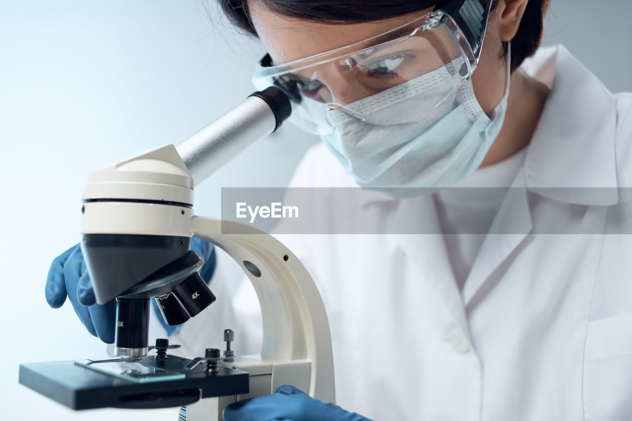 female dentist examining patient in laboratory