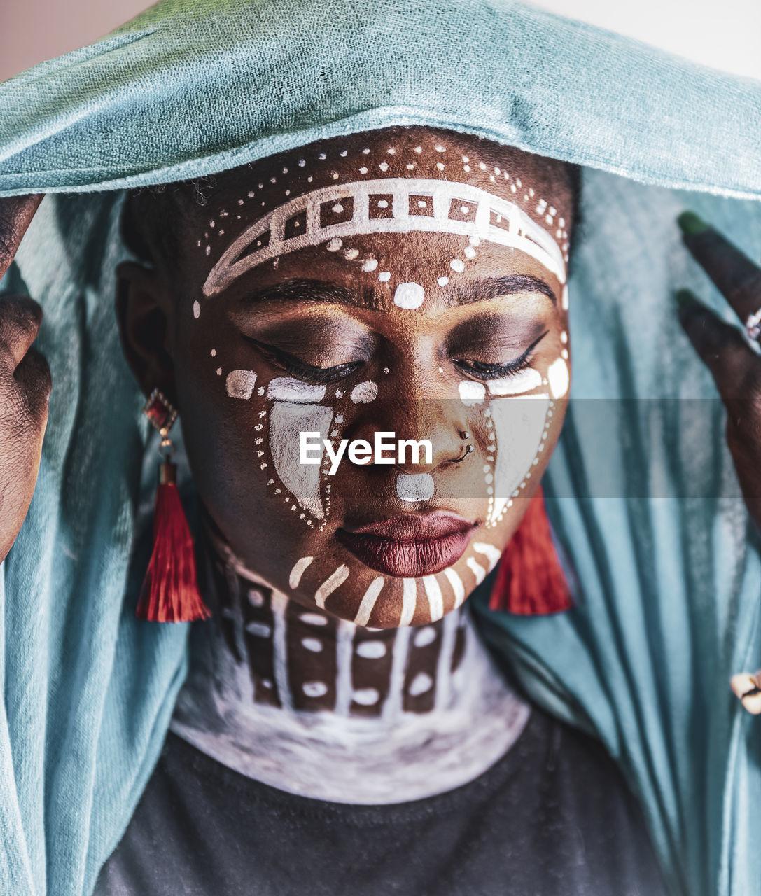 Woman from africa wearing headdress and tribal painting