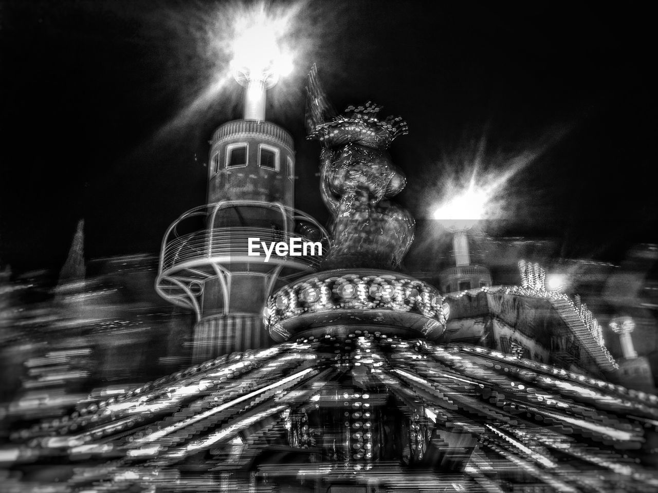 night, illuminated, outdoors, amusement park ride, long exposure, amusement park, no people, architecture, blurred motion, built structure, building exterior, street light, low angle view, sky, carousel, city