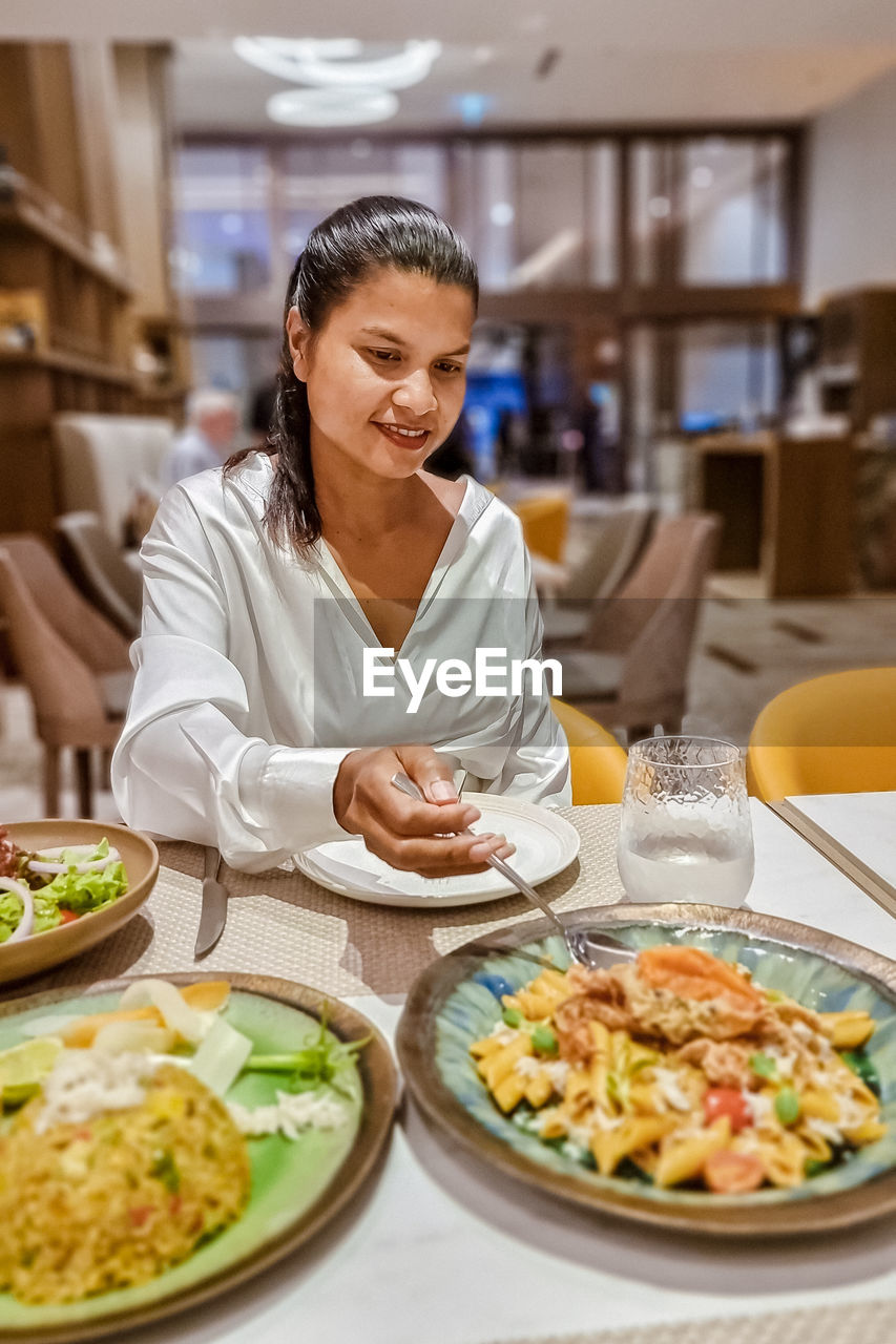 portrait of woman having food at restaurant