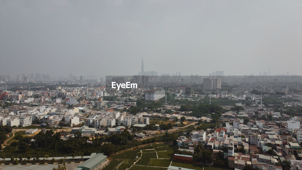 HIGH ANGLE VIEW OF BUILDINGS AGAINST SKY