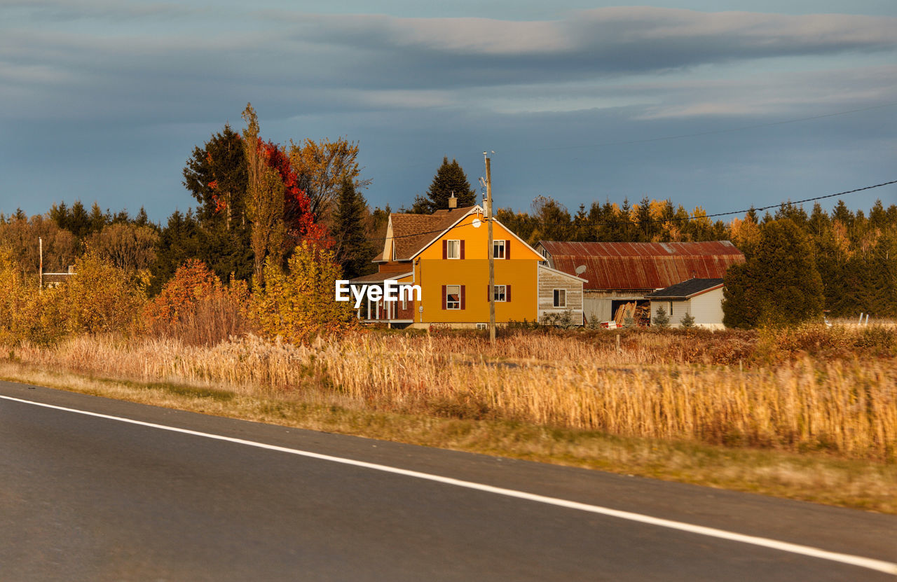 ROAD BY BUILDINGS AGAINST SKY