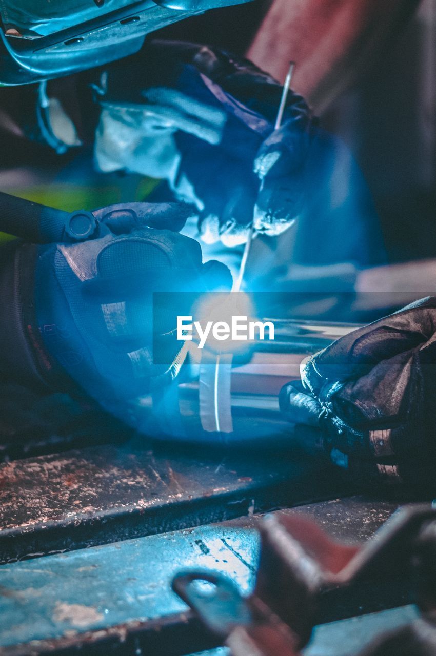 Close-up of  hands welding a tube