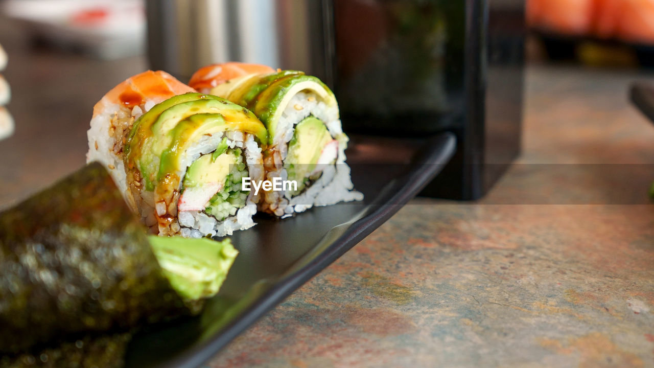 food and drink, food, healthy eating, freshness, wellbeing, produce, meal, dish, vegetable, indoors, cuisine, no people, close-up, fast food, selective focus, sushi, table, still life, seafood, focus on foreground, fruit, restaurant, avocado