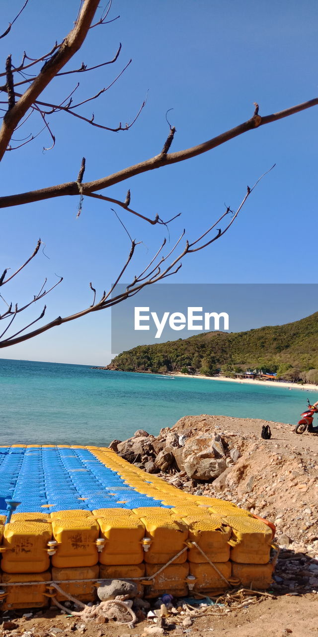 Scenic view of beach against clear blue sky