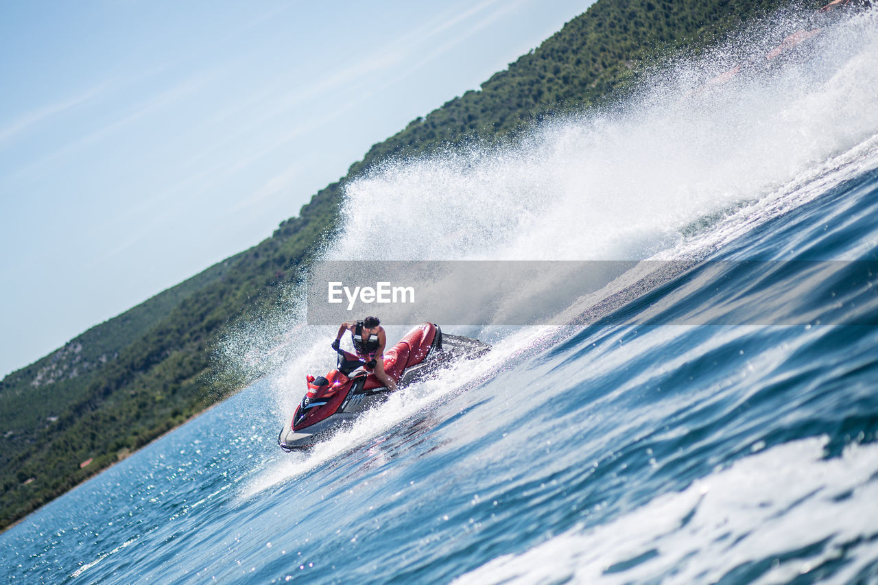 Man riding jet boat on sea