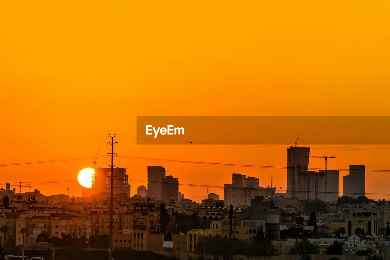 Cityscape against sky during sunset