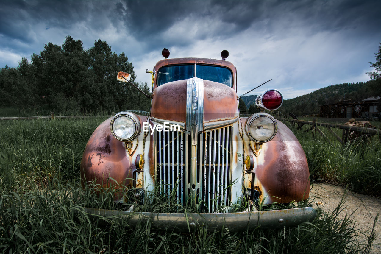 Abandoned vintage car of field