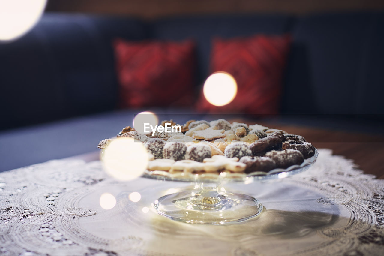 Traditional christmas cookies with decorations on table at living room.