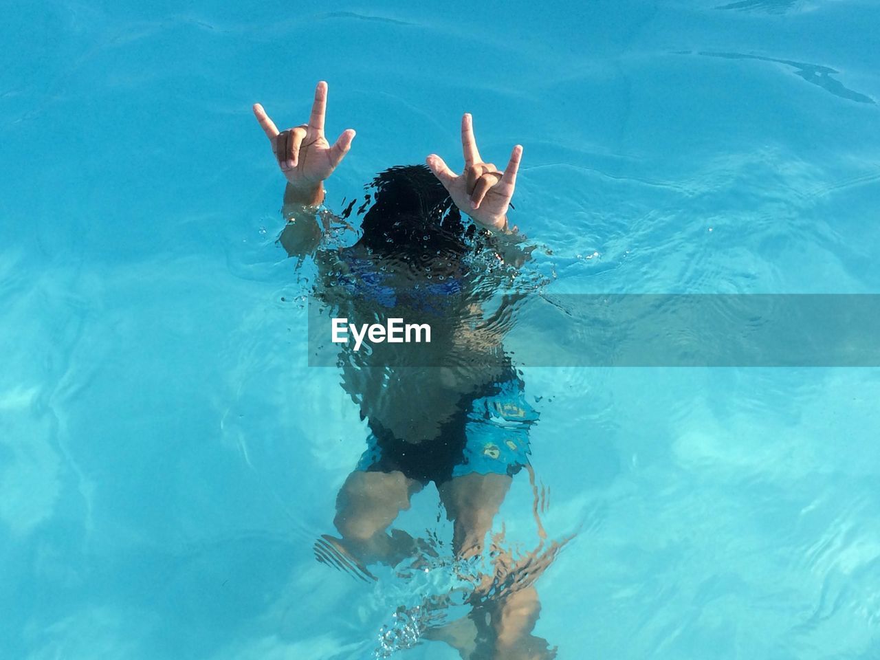 High angle view of boy swimming in pool