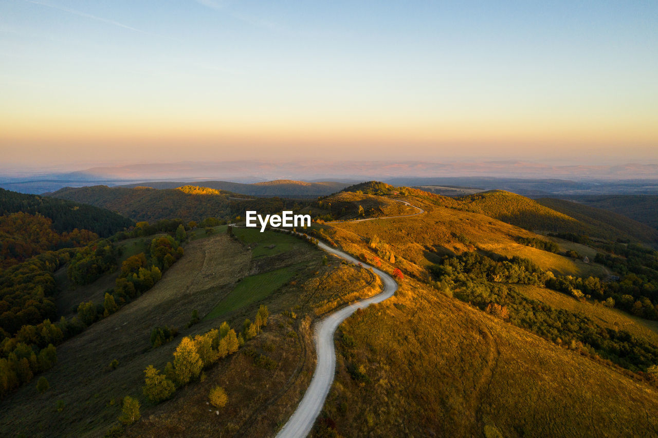 Aerial drone view of winding mountain road at autumn