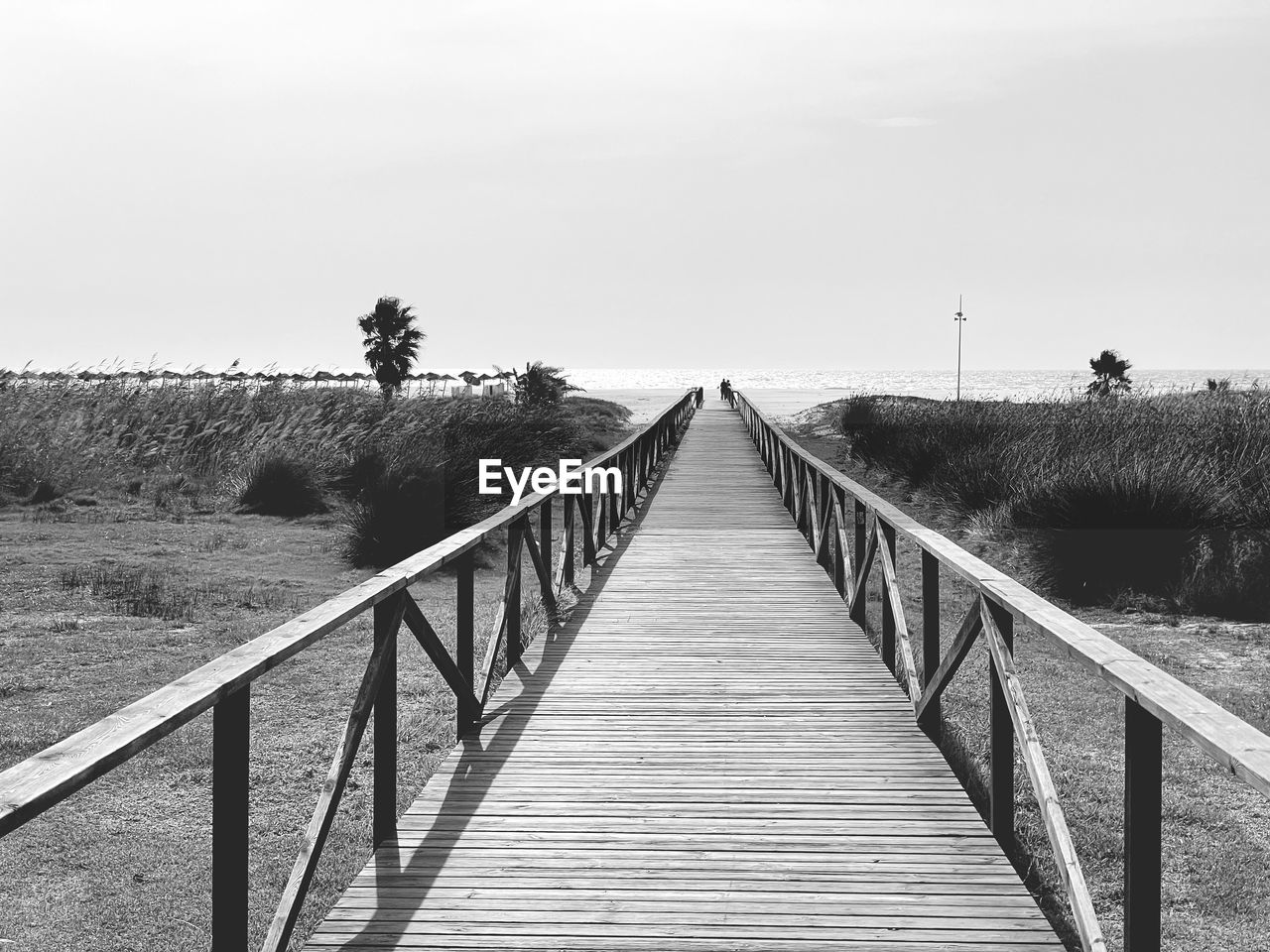 FOOTBRIDGE ON FOOTPATH AGAINST SKY