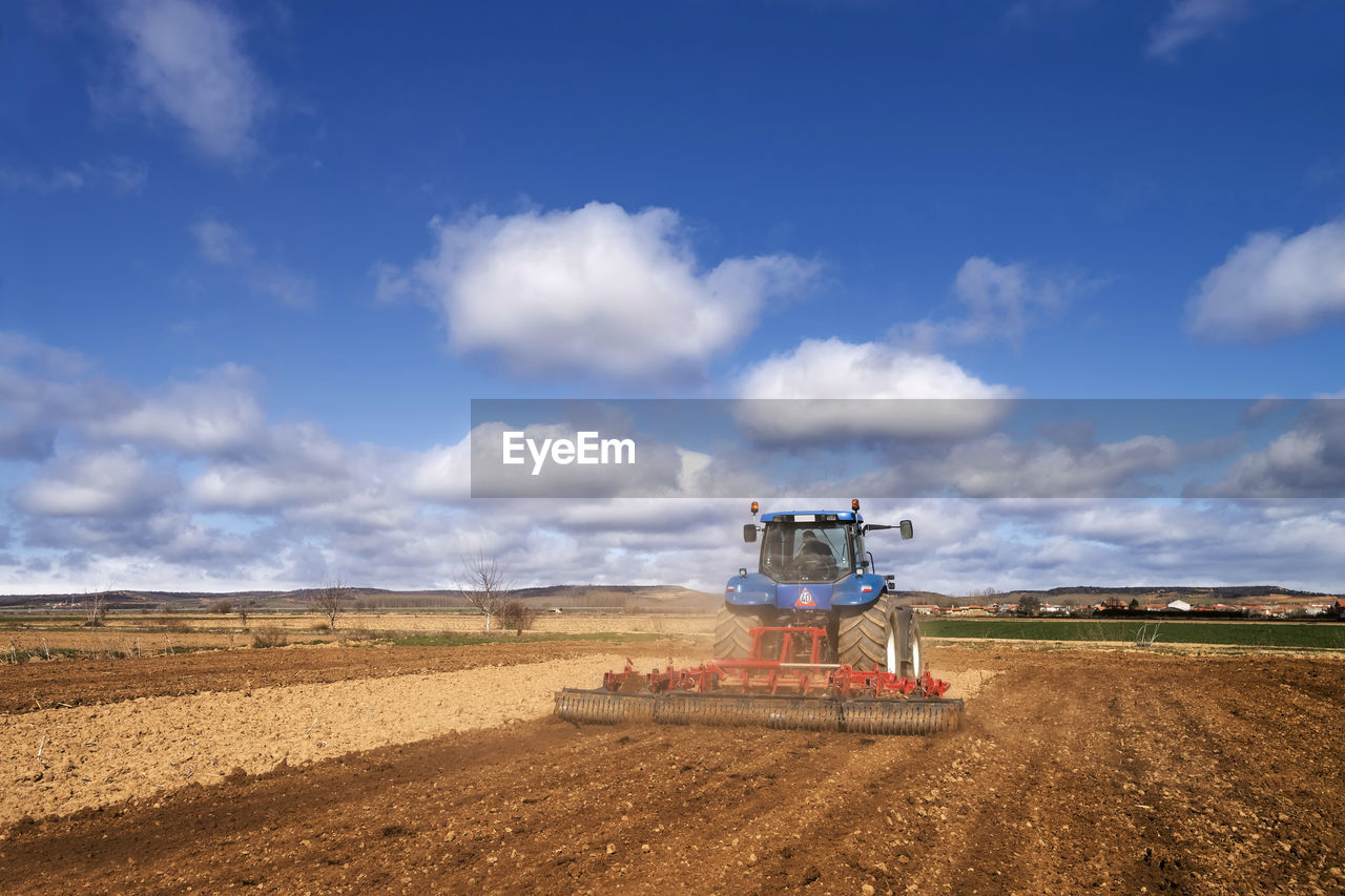 Tractor modern , farm equipment woriking in field