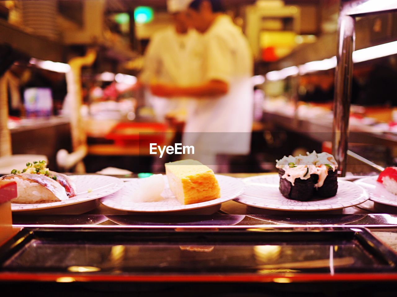 Sushi served in plates on kitchen platform