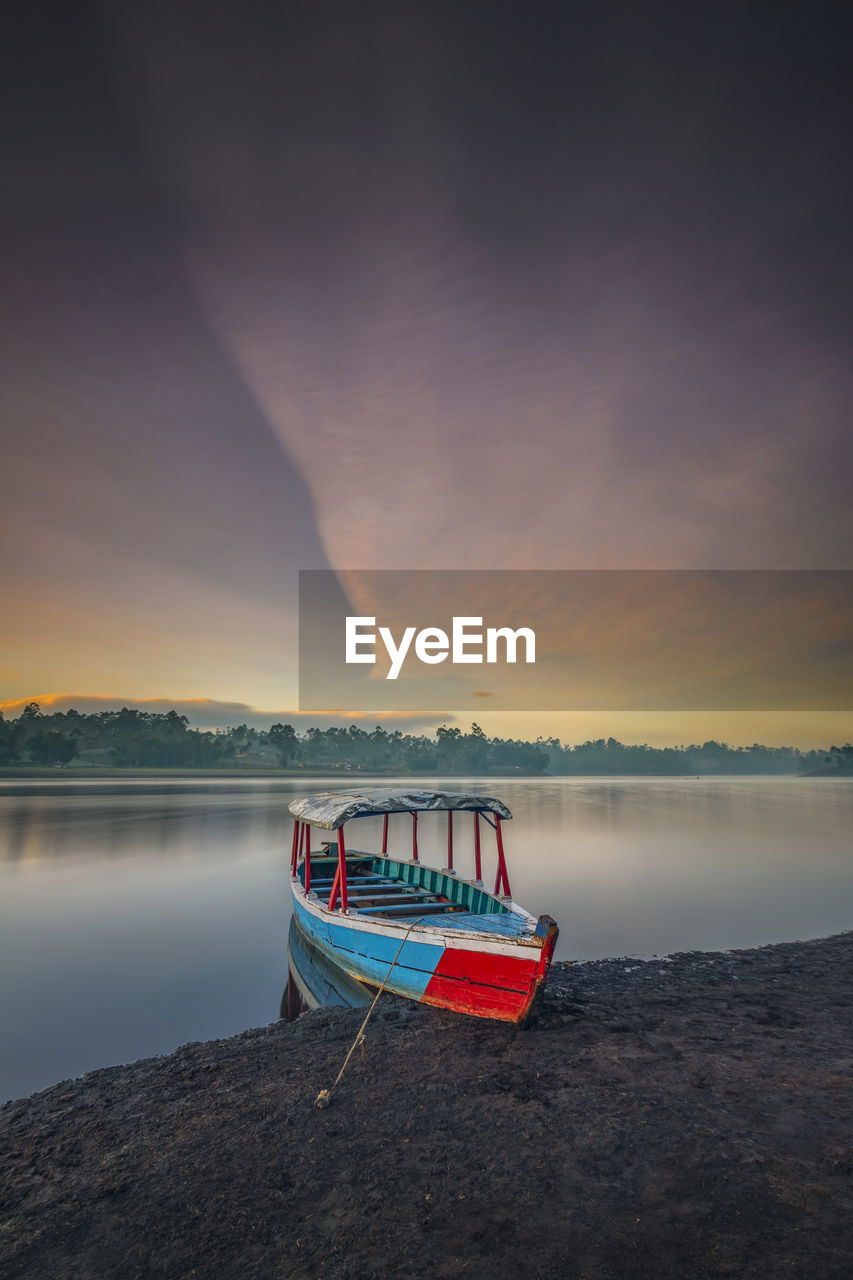 The boat rests with a beautiful view in the morning