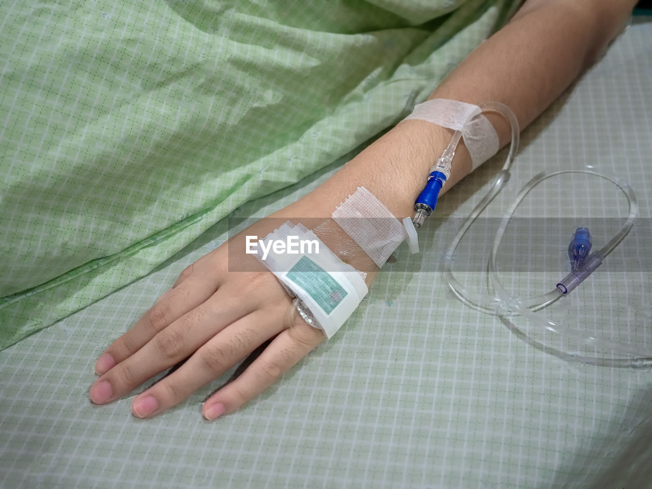 High angle view of woman with medical equipment on bed in hospital