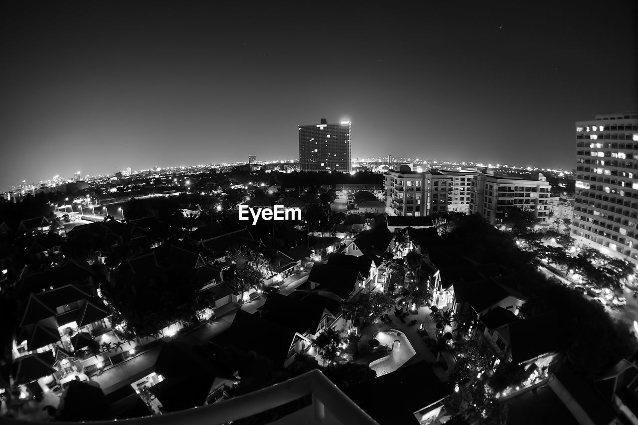 High angle view of illuminated cityscape against sky at night