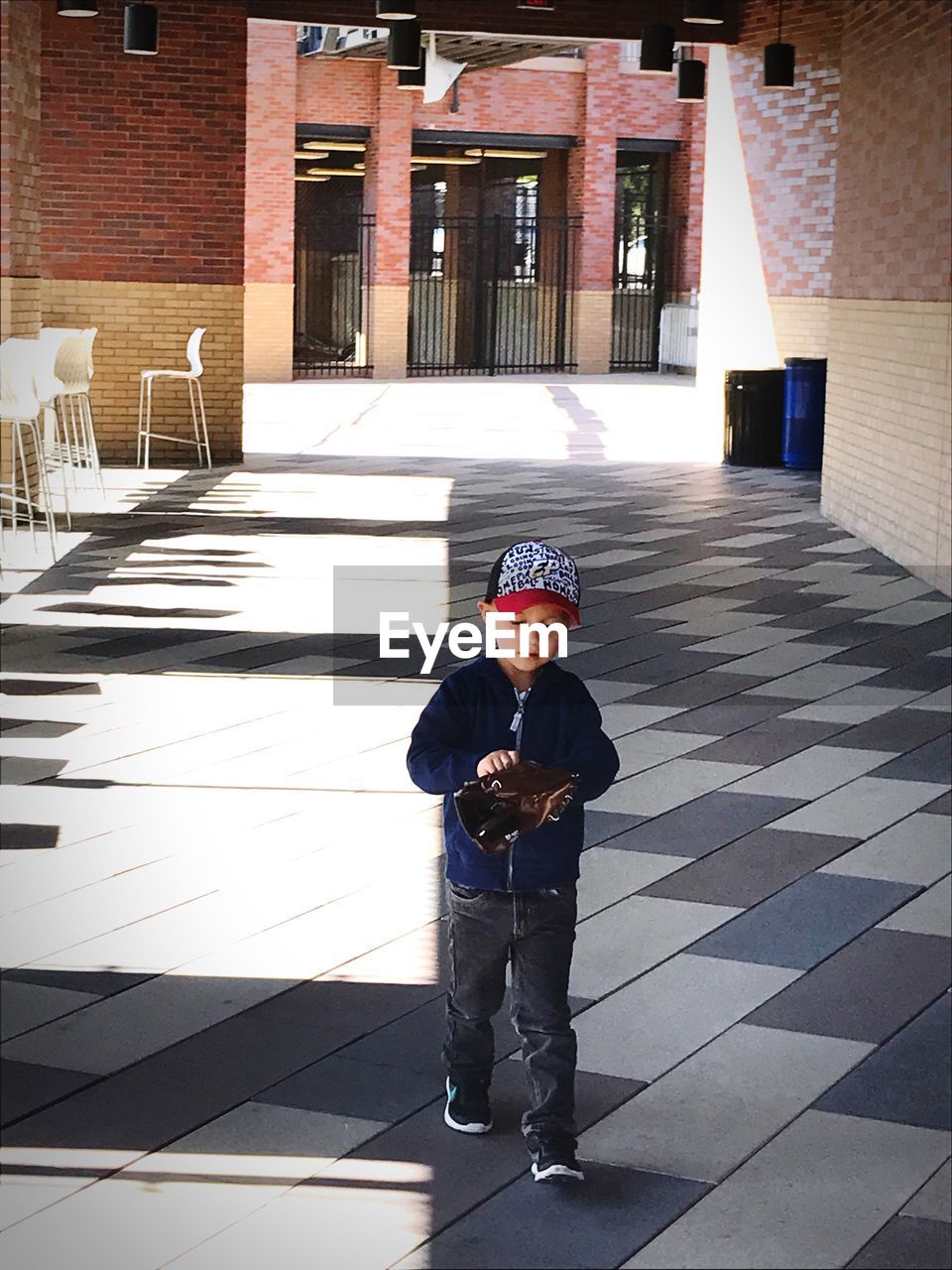 FULL LENGTH OF BOY WORKING ON UMBRELLA