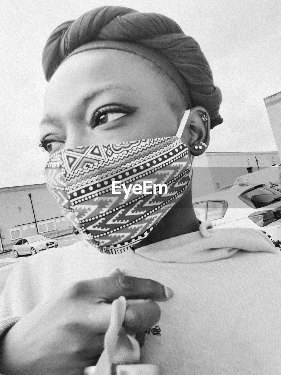 CLOSE-UP PORTRAIT OF YOUNG MAN HOLDING SUNGLASSES