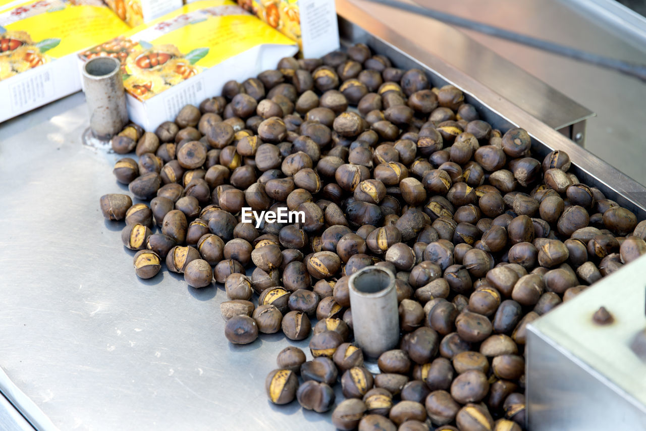 High angle view of roasted chestnuts for sale at market