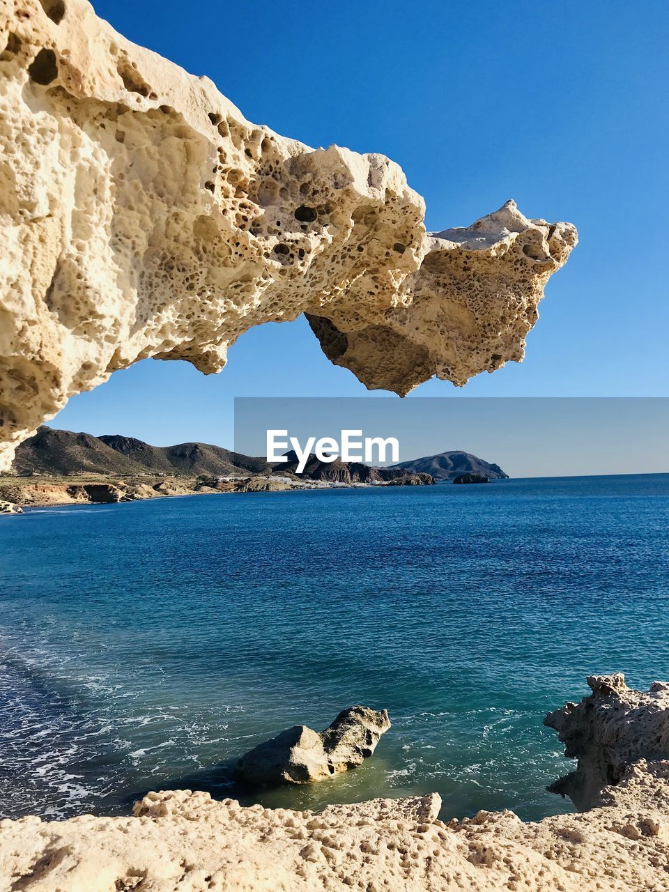 Scenic view of sea against clear blue sky