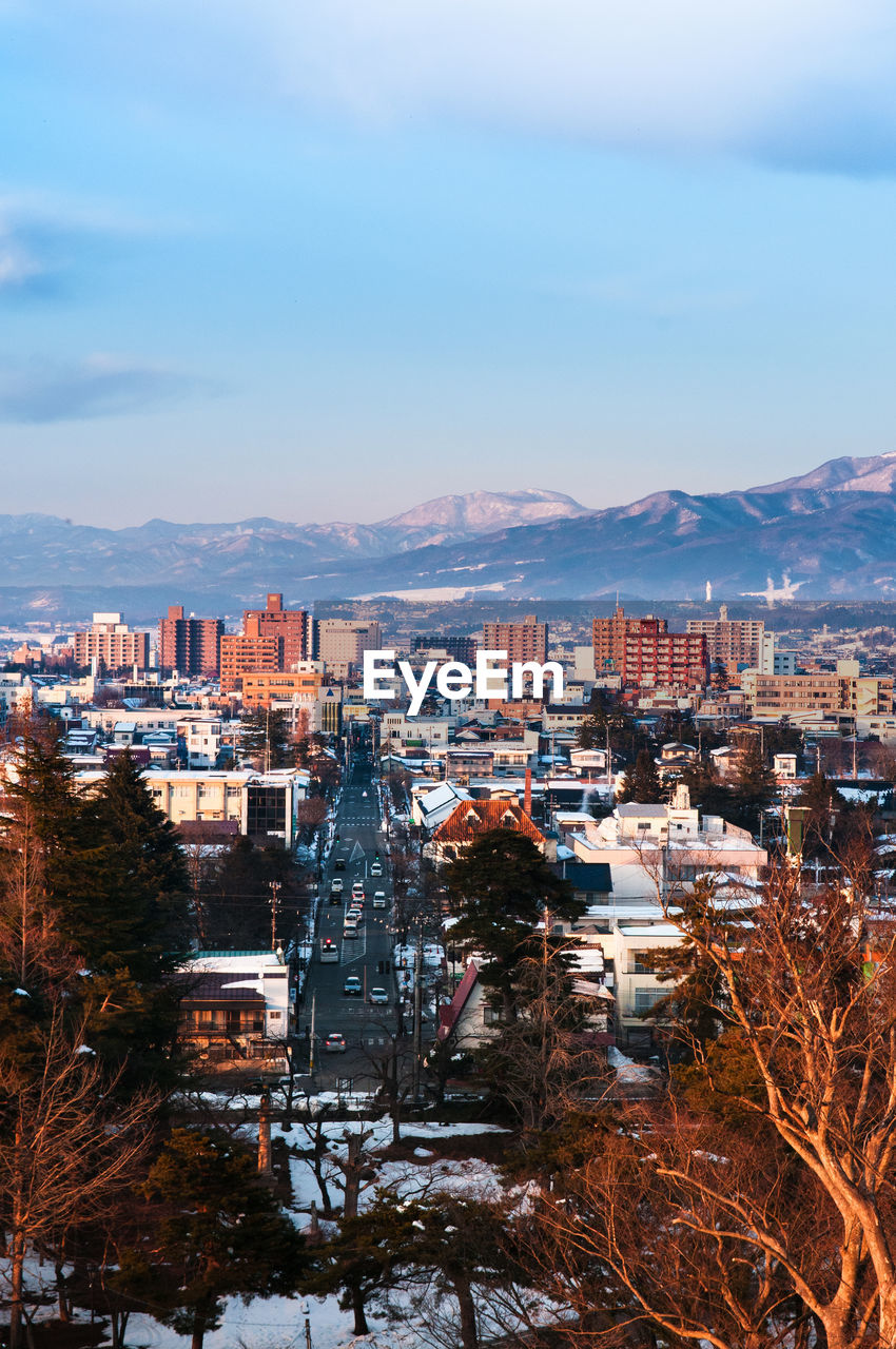 Aizu wakamatsu, japan. city scenery with snow mountain in evening