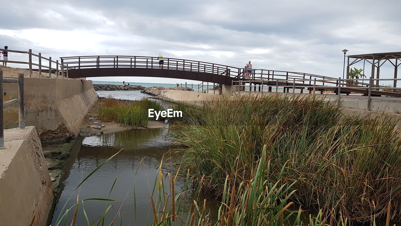 VIEW OF BRIDGE OVER RIVER AGAINST SKY