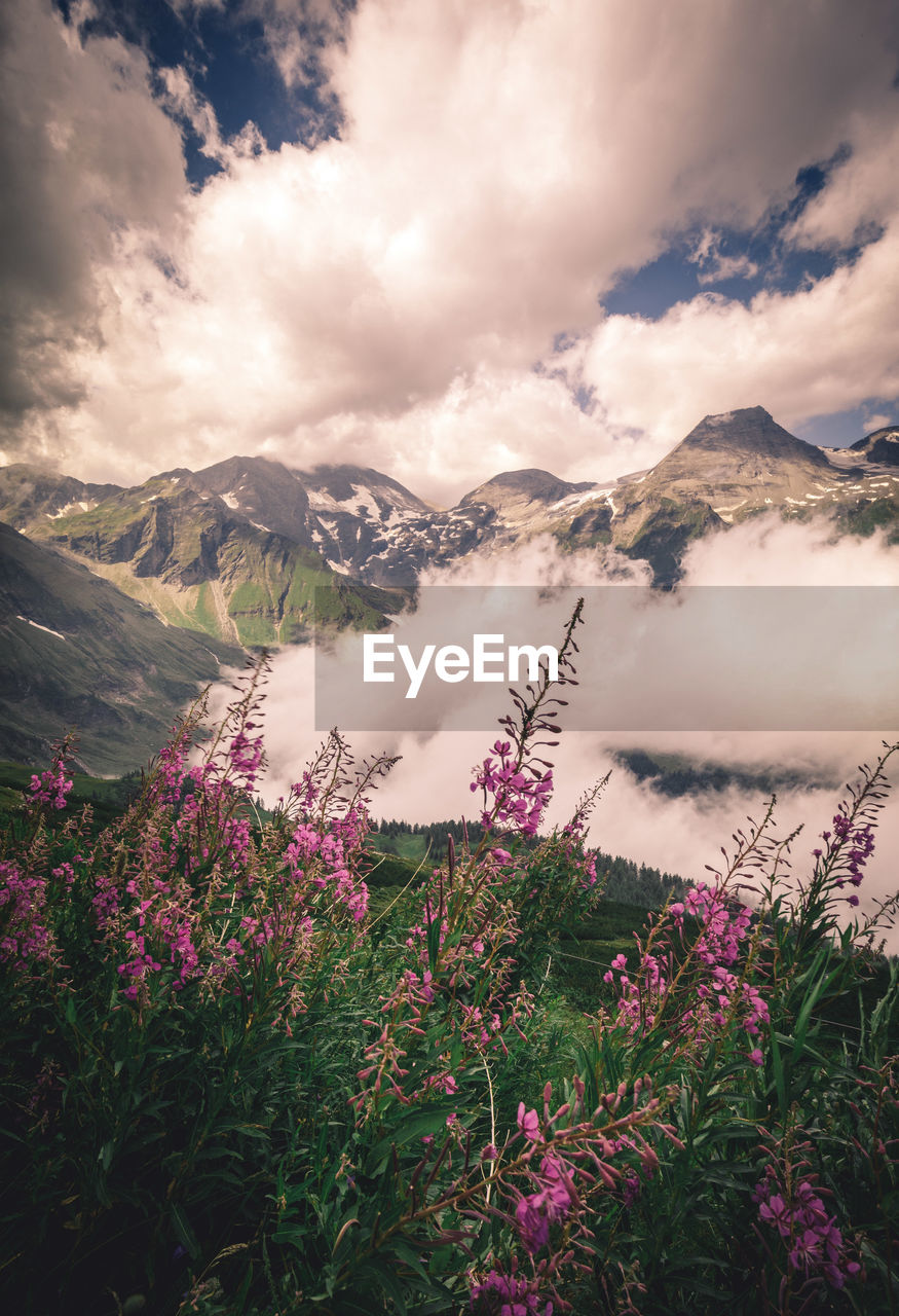 Scenic view of mountains against cloudy sky