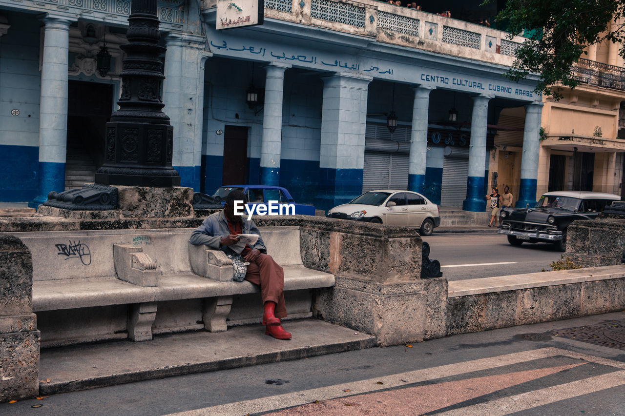 WOMAN STANDING ON RAILING