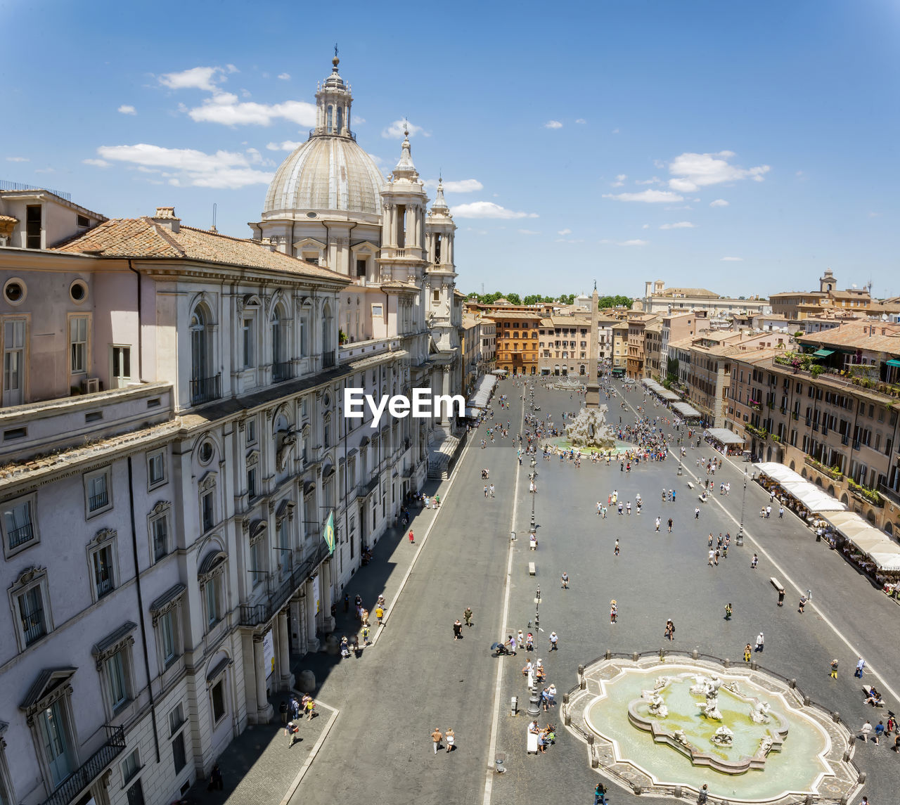 Top view of piazza navona in rome with a crowd of unrecognizable tourists on a sunny day. 