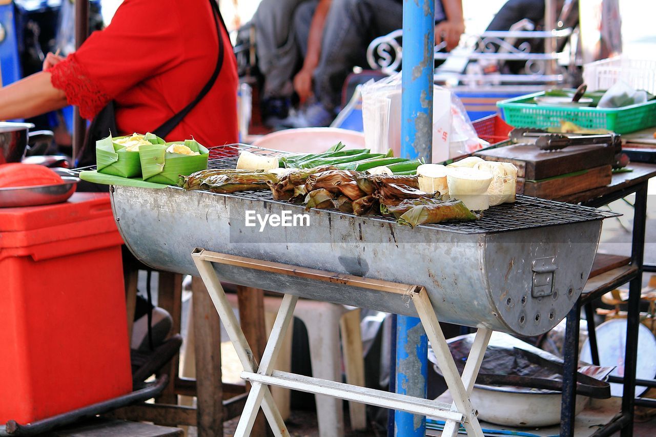Food cooking on barbecue grill at market stall