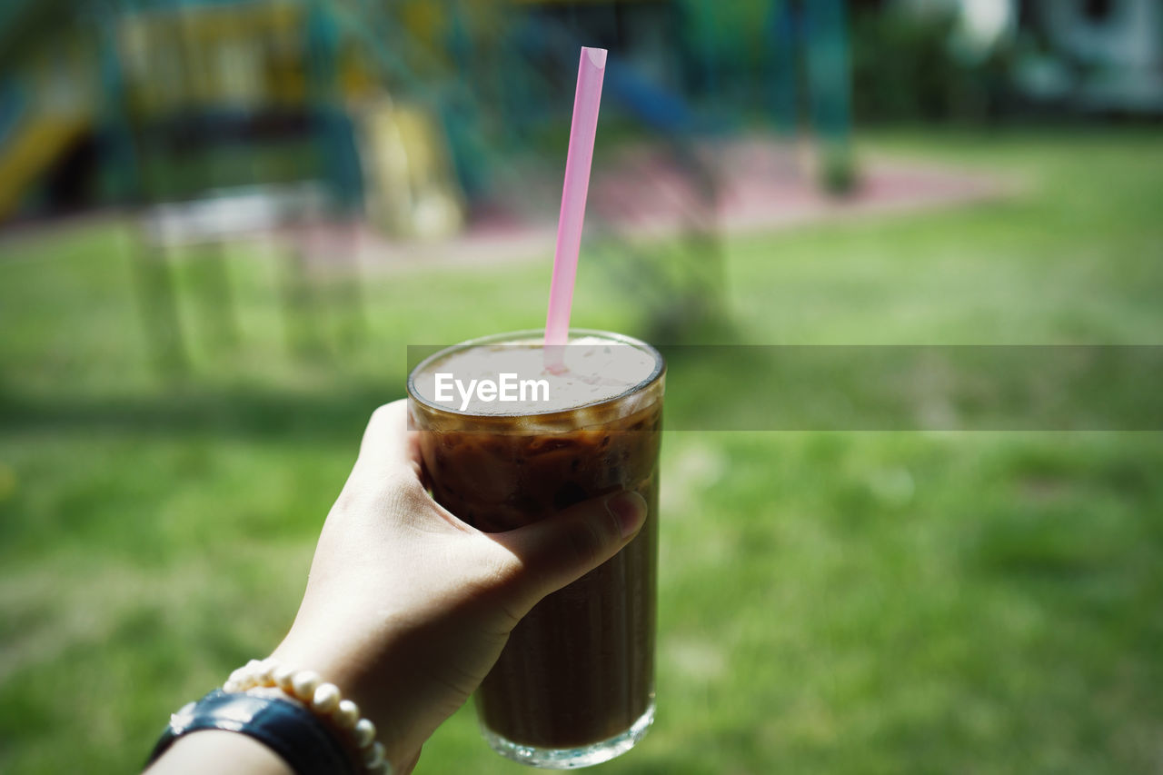 cropped hand of person holding coffee