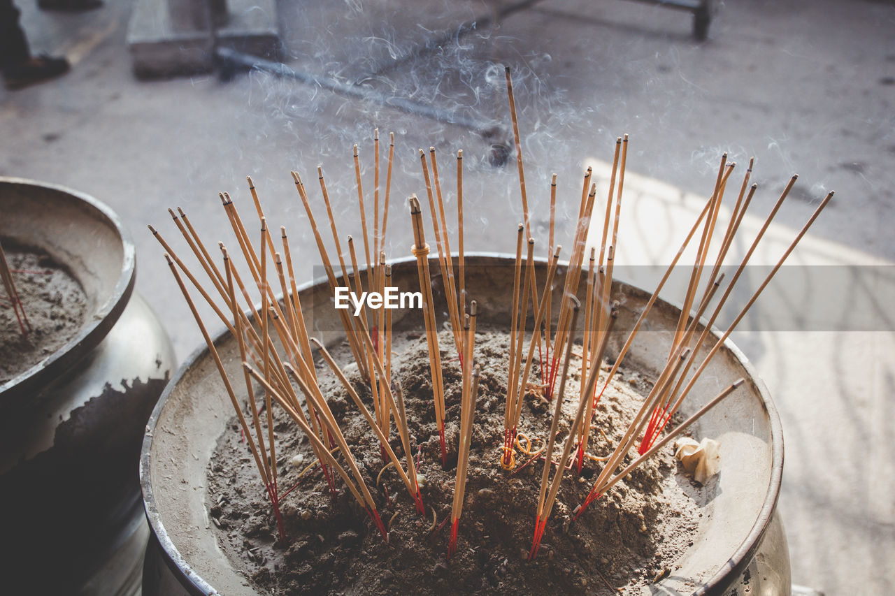 Close-up of incense sticks in container