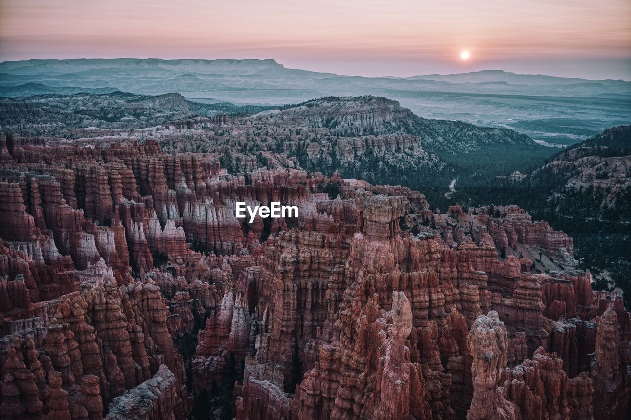Panoramic view of bryce canyon landscape with sunrise in background