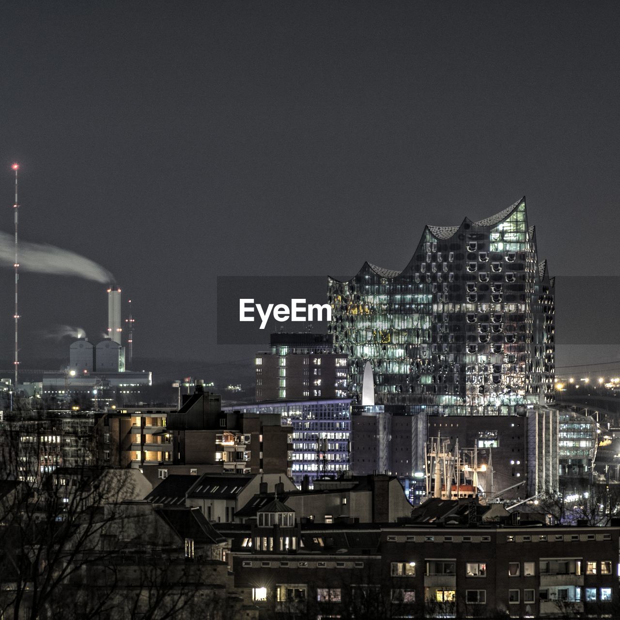 Illuminated cityscape against sky at night