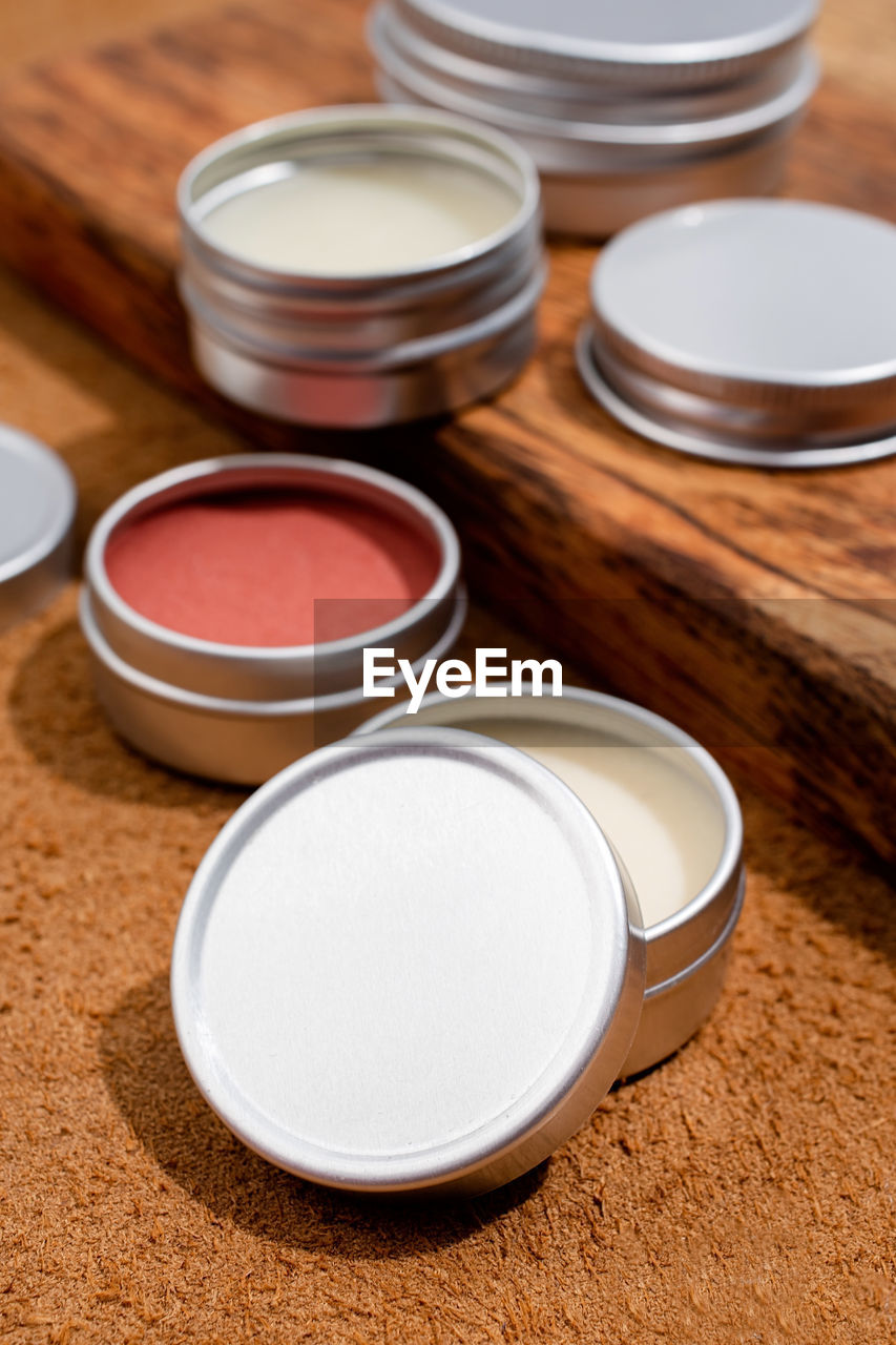 powder, cup, human eye, indoors, container, skin, group of objects, close-up, brown, food and drink, studio shot, wood, high angle view