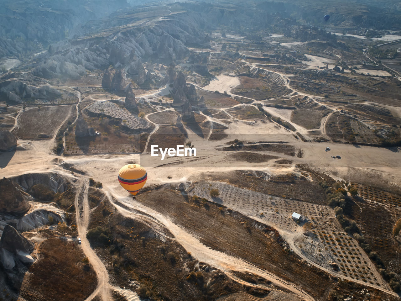 Aerial view of hot air balloon over landscape against sky