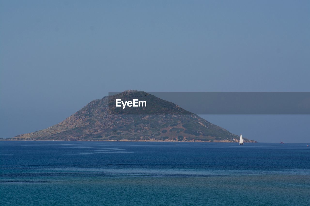 Scenic view of sea against clear blue sky