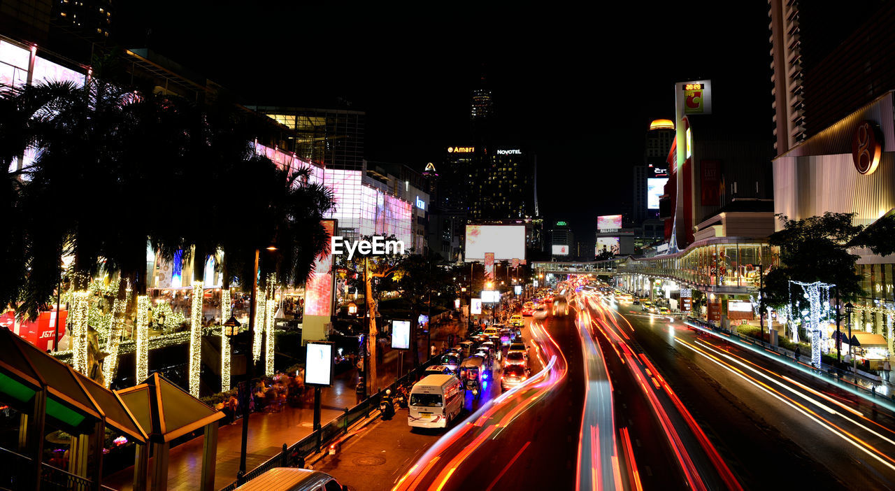 night, city, illuminated, architecture, transportation, street, motion, building exterior, built structure, road, city life, city street, traffic, light trail, long exposure, mode of transportation, evening, cityscape, urban area, travel destinations, motor vehicle, car, metropolis, speed, blurred motion, downtown, light, lighting equipment, travel, tail light, infrastructure, outdoors, building, metropolitan area, on the move, street light, no people, sign, land vehicle, highway, office building exterior, nightlife, nature, skyscraper