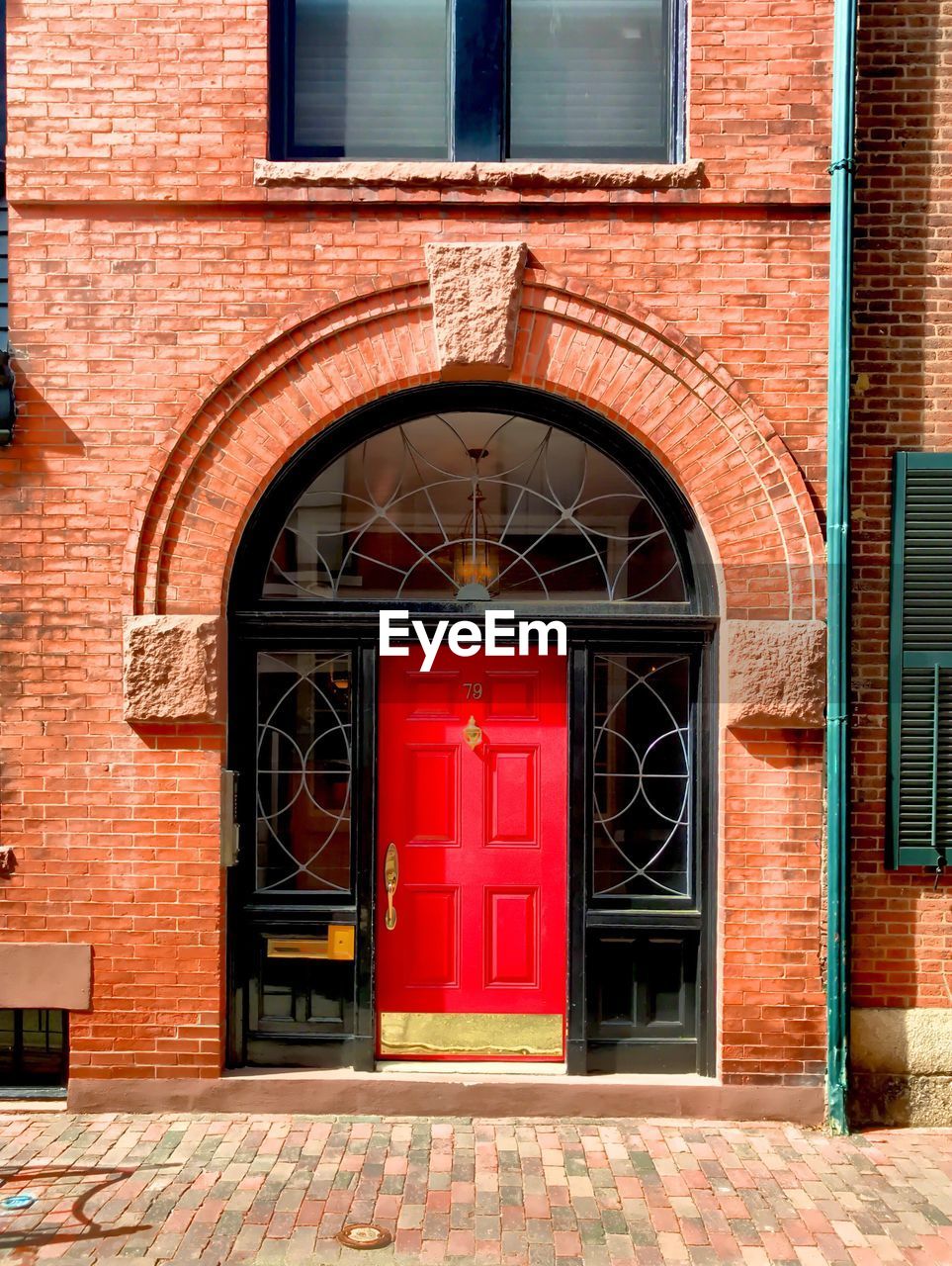 ENTRANCE OF BUILDING WITH RED CLOSED DOOR