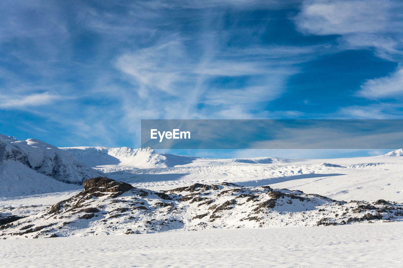 Scenic view of snowcapped mountains against sky