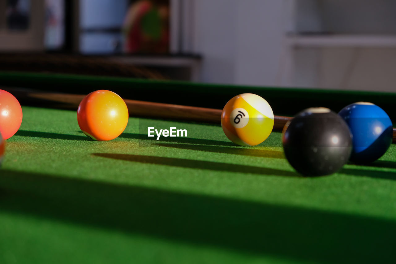 CLOSE-UP OF COLORFUL BALL ON TABLE